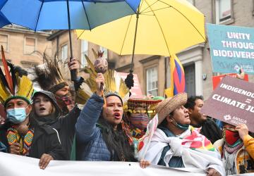 A group of activists with umbrellas, signs, posters