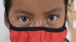 A close up of a girl's face with a mask. 