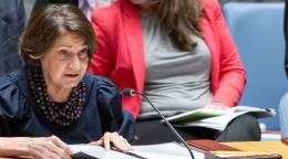 Women in white chef's uniforms sit at a table.