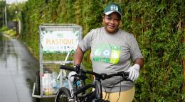 Christina Perrine collecting rubbish by bike