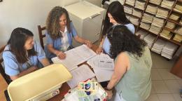 A group of Albanian women working around a table.