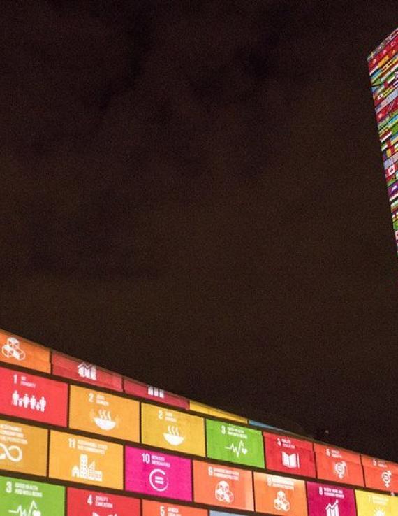 A colourful projection of the UN sustainable development goals appearing on the walls and the sides of the UN Headquarters building in New York