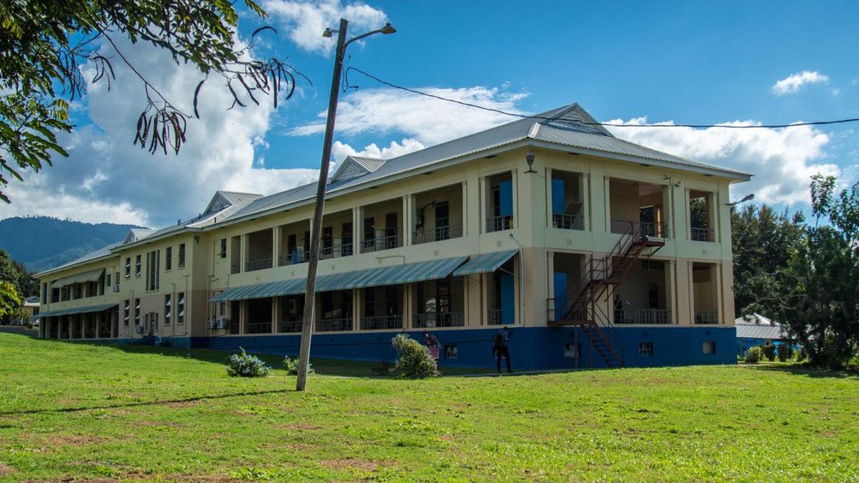 An image of a yellow building on a beautiful day. 