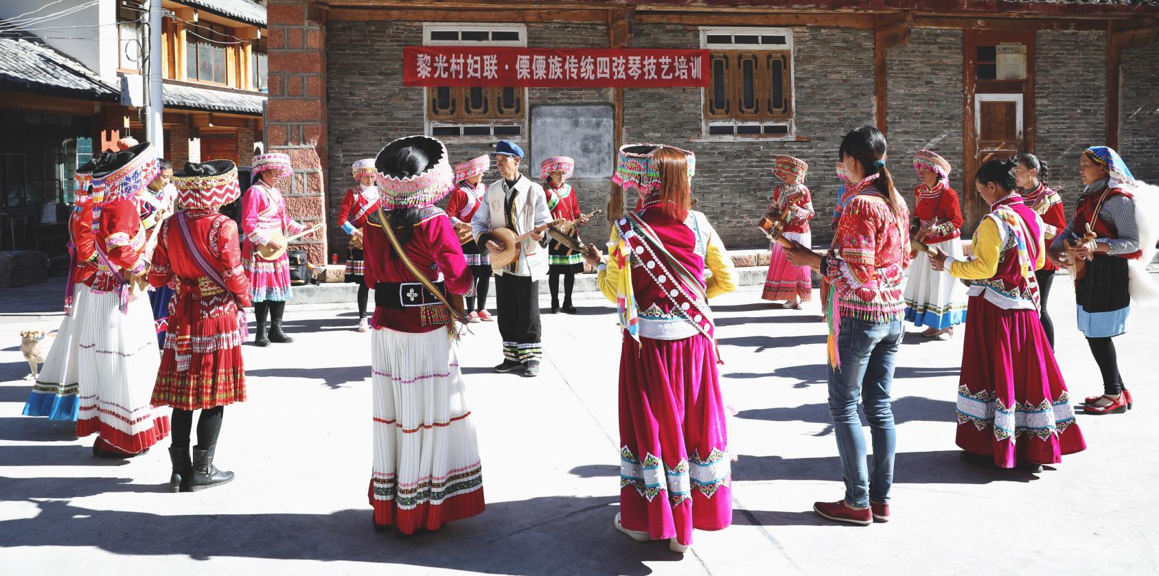 Women being trained to play Lisu musical instrument Qiben. 