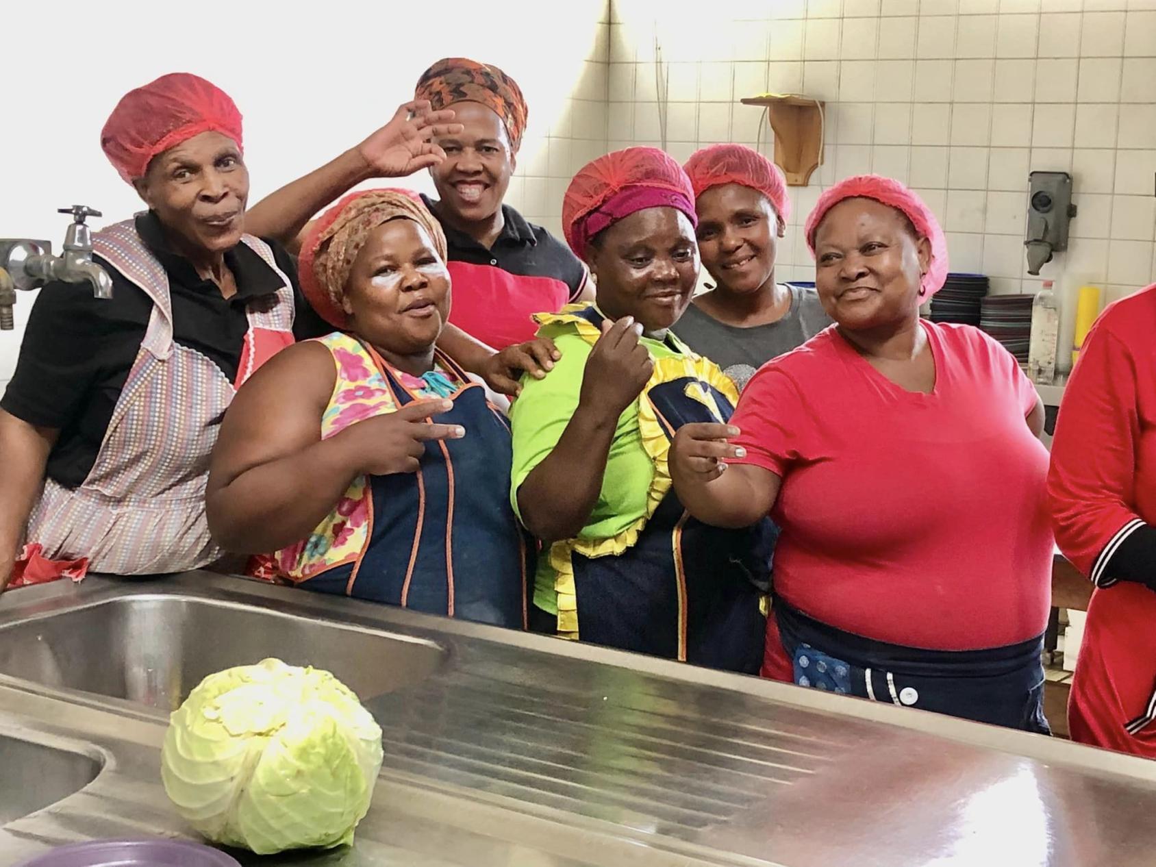 Women in red clothes in a shelter kitchen