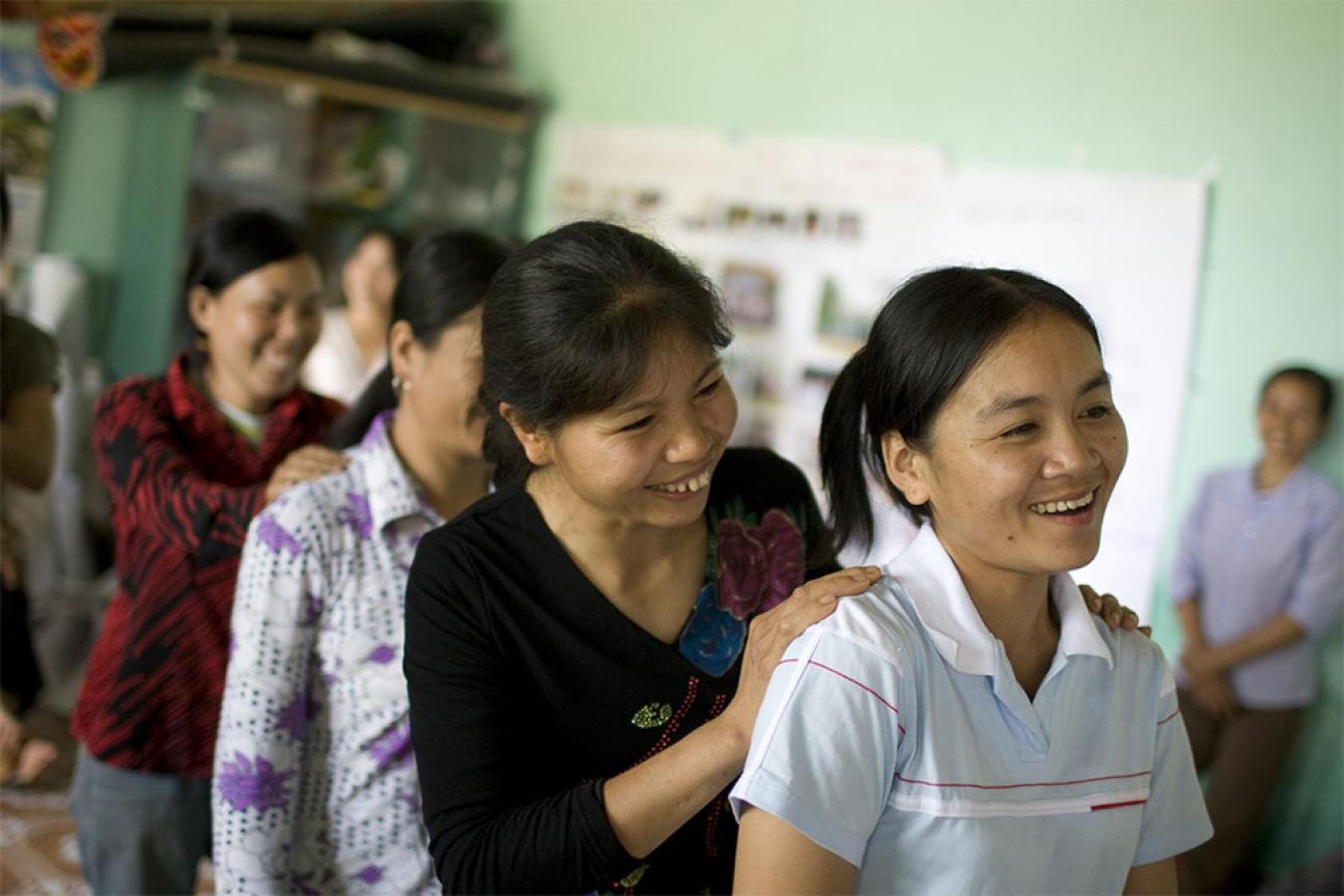 A group of women stand in a line in Viet Nam
