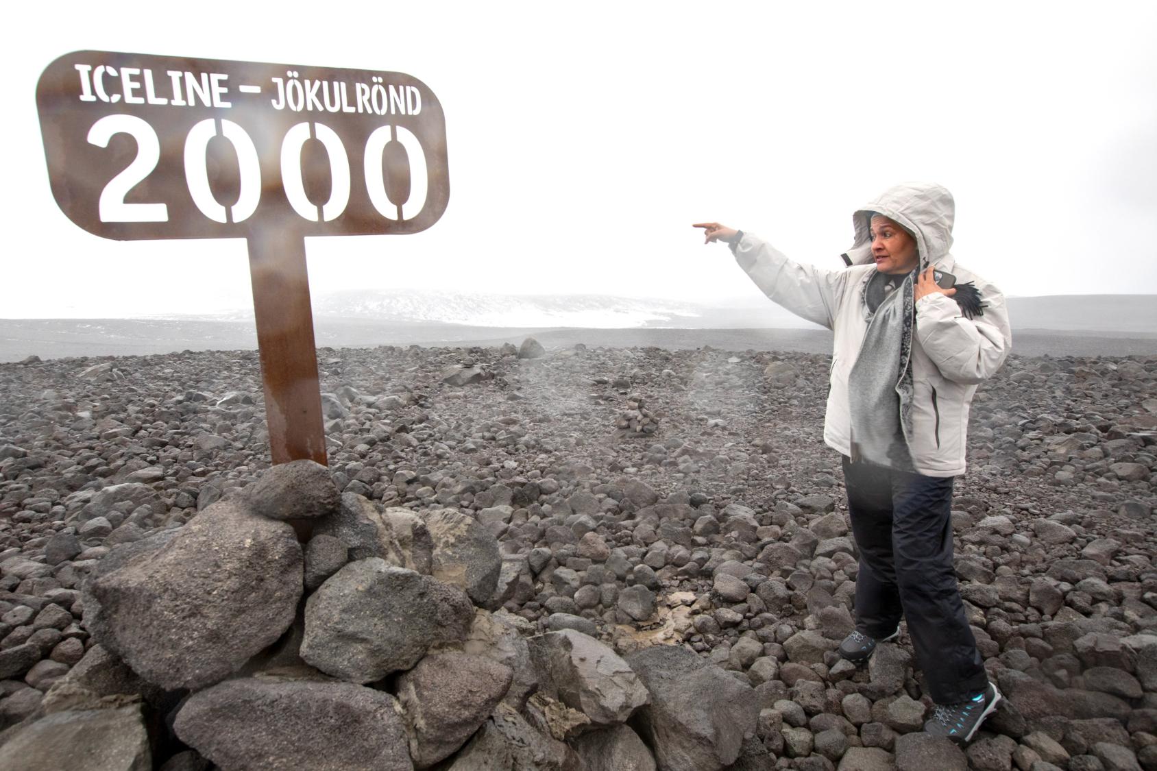 The deputy UN chief visits a glacier in Iceland, with rocky terrain and ice in the background.