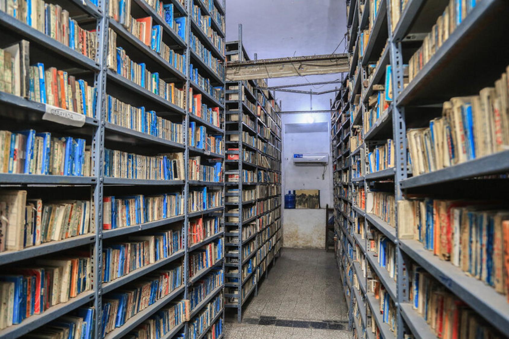 A row of shelves with various audio cassettes in different colours displayed
