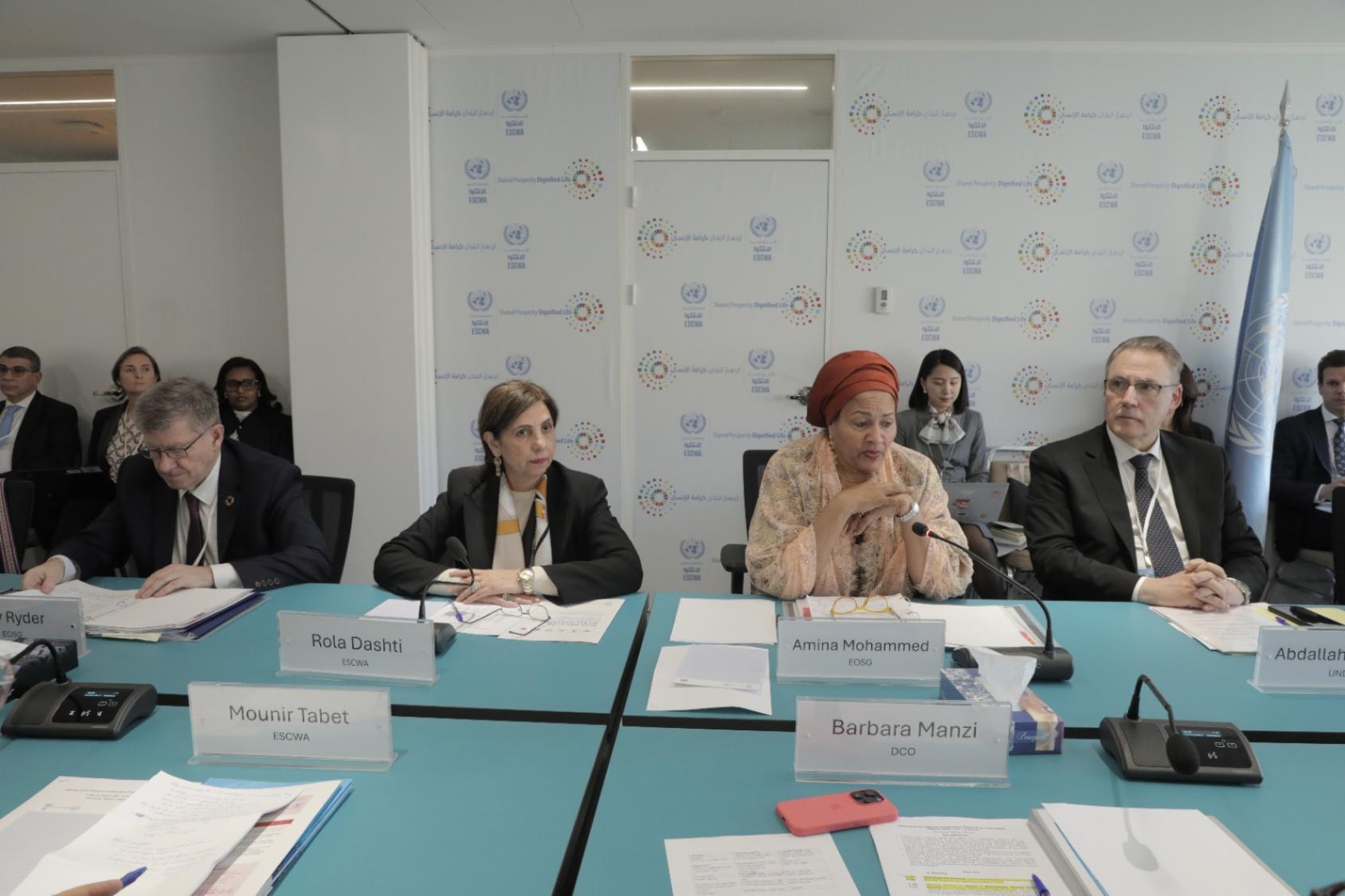 A row of four people at a table, two men on the outside and two women on the inside.