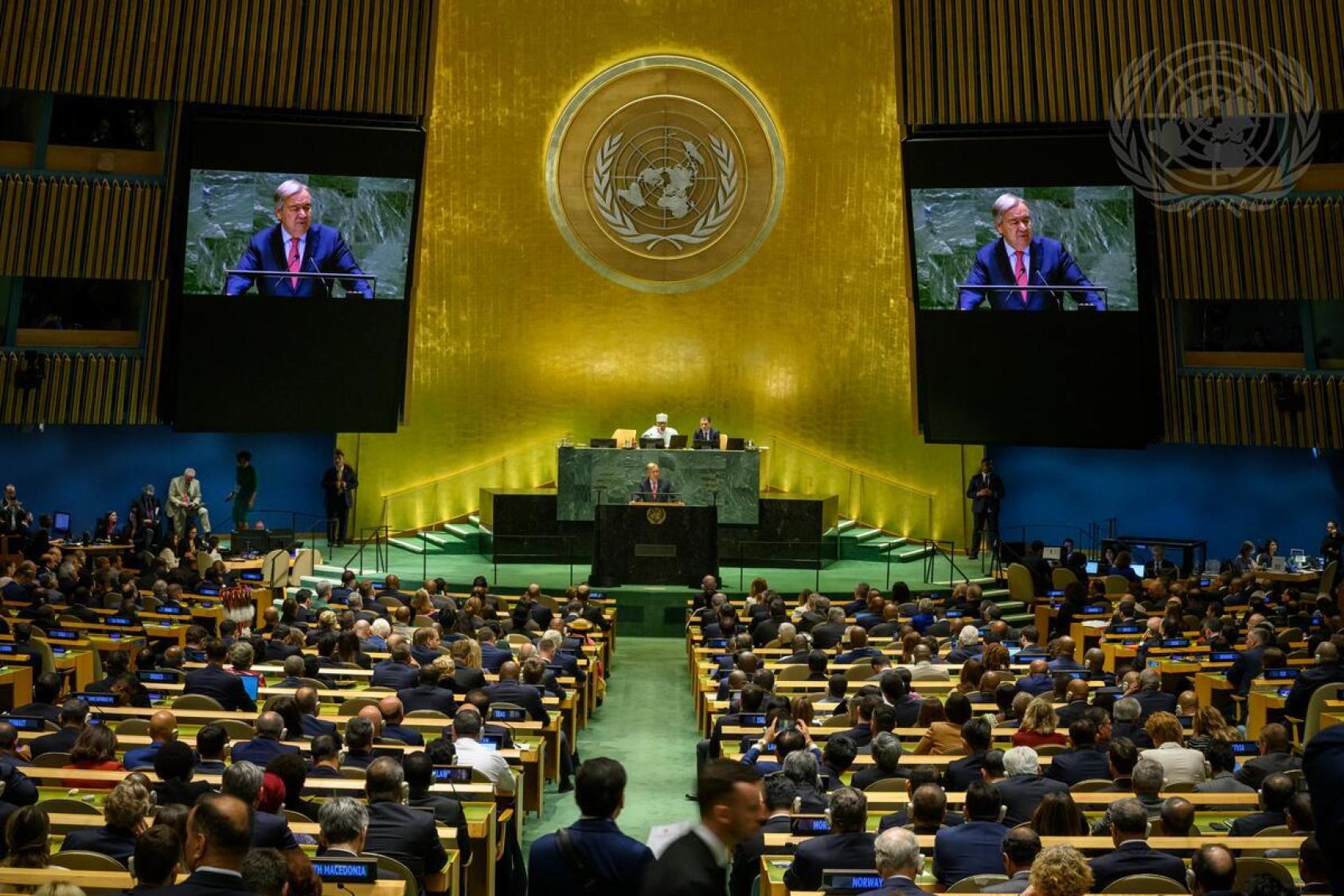 An aerial view of the UN General Assembly hall with the image of the Secretary-General on the screens