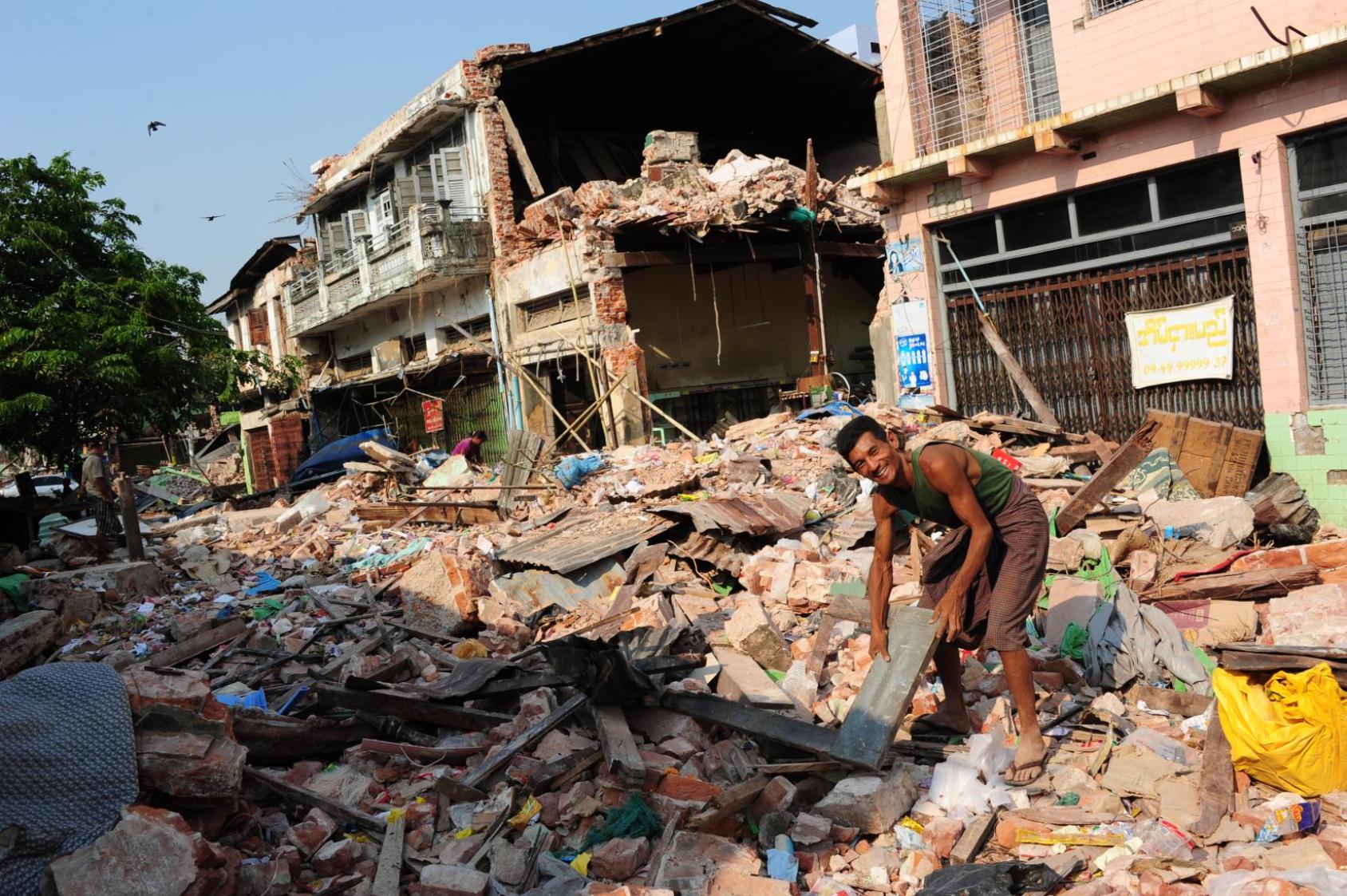 Earthquake survivors comb through ruins of their houses in Pyinmana