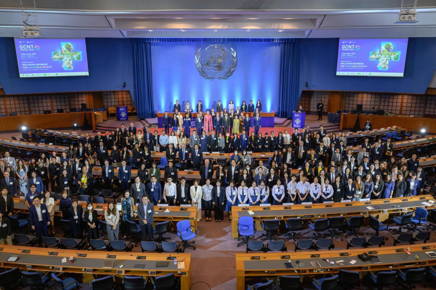 قاعة كبيرة في بانكوك، تايلاند، تضم مشاركين تحت شعار الأمم المتحدة خلال مناقشات حول التزامات القطاع الخاص بالحياد الكربوني.