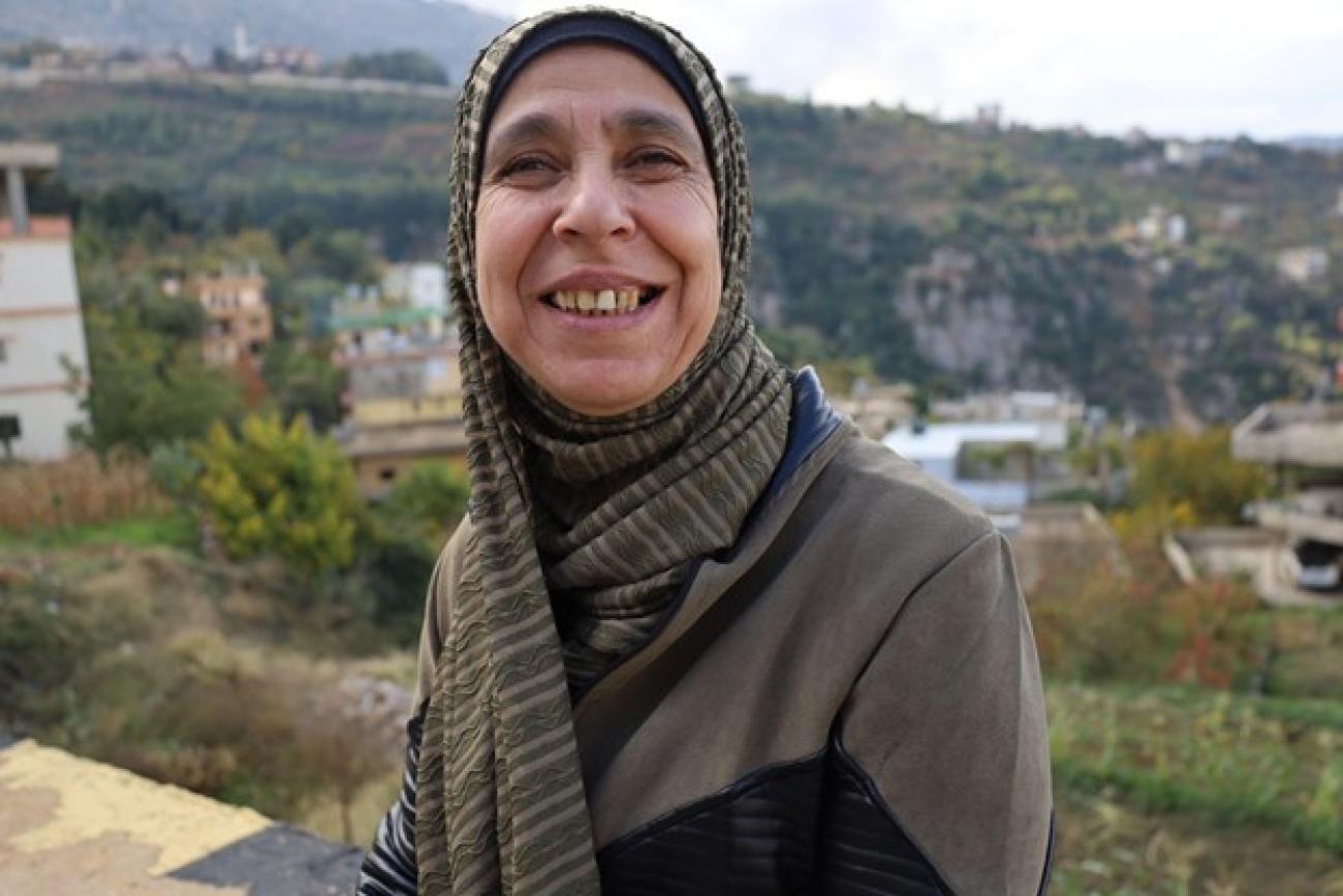 Woman in a headscarf smiling at the camera