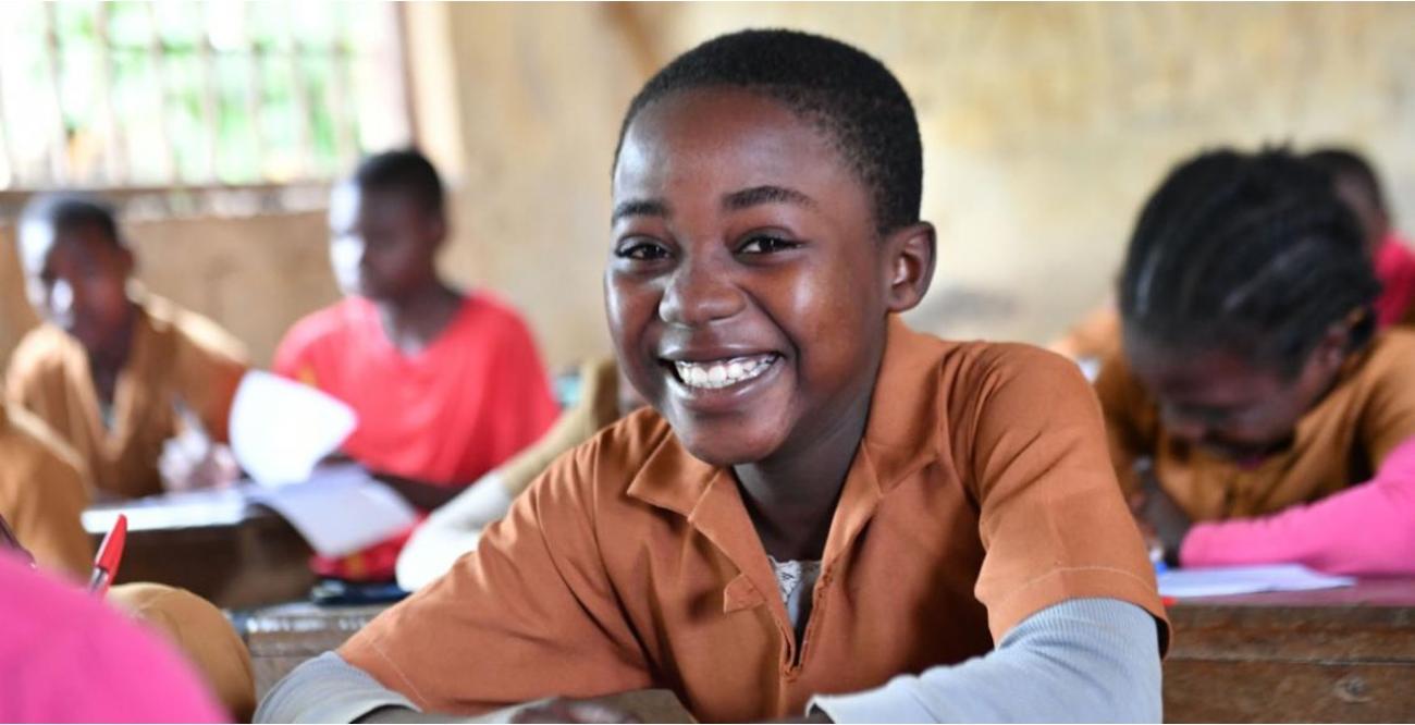Young boy sitting in a school in Cameroon