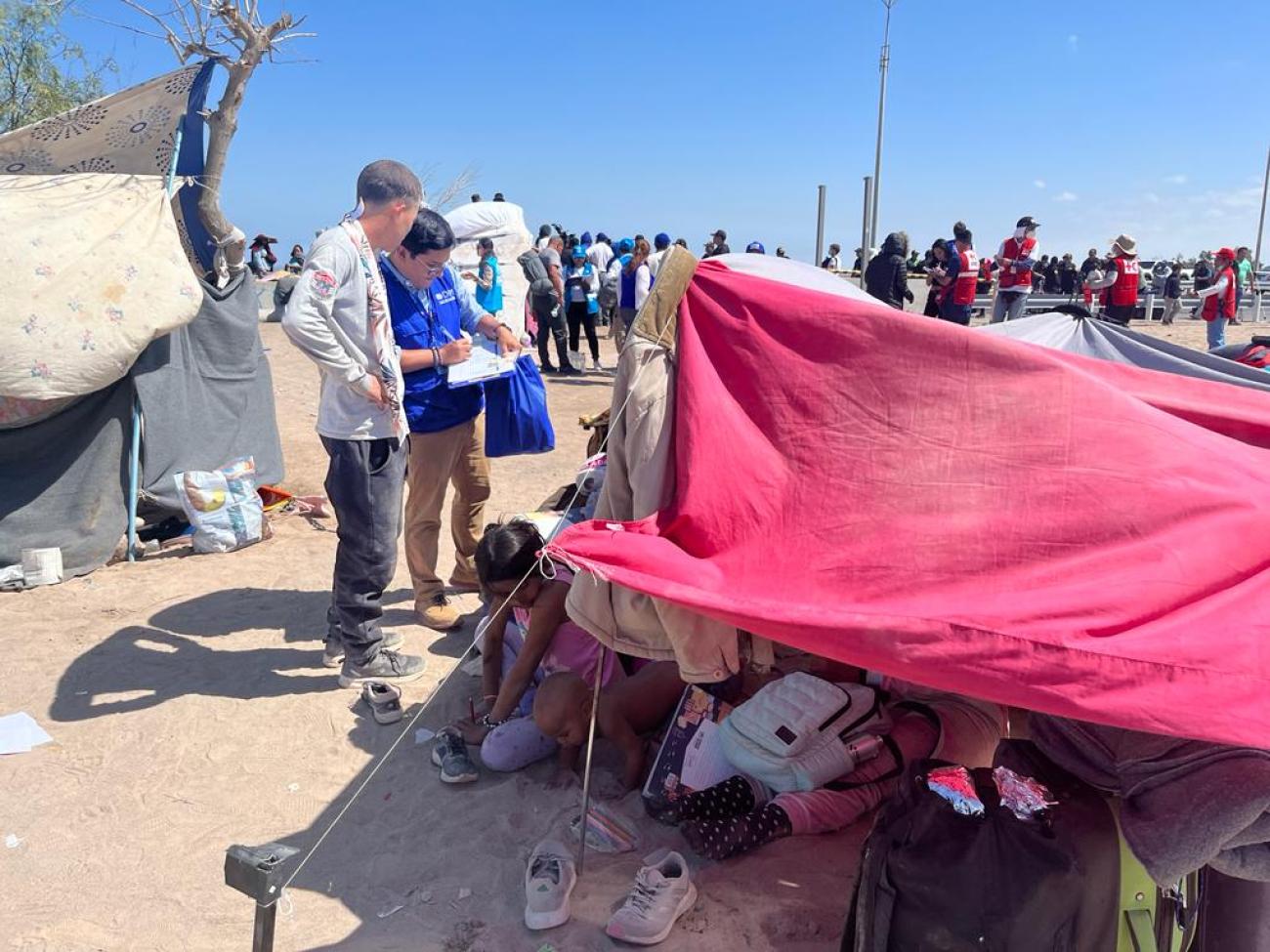 Aid workers speak with displaced people in norther Peru.