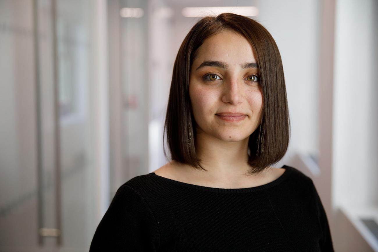 A woman in a black shirt with short brown hair