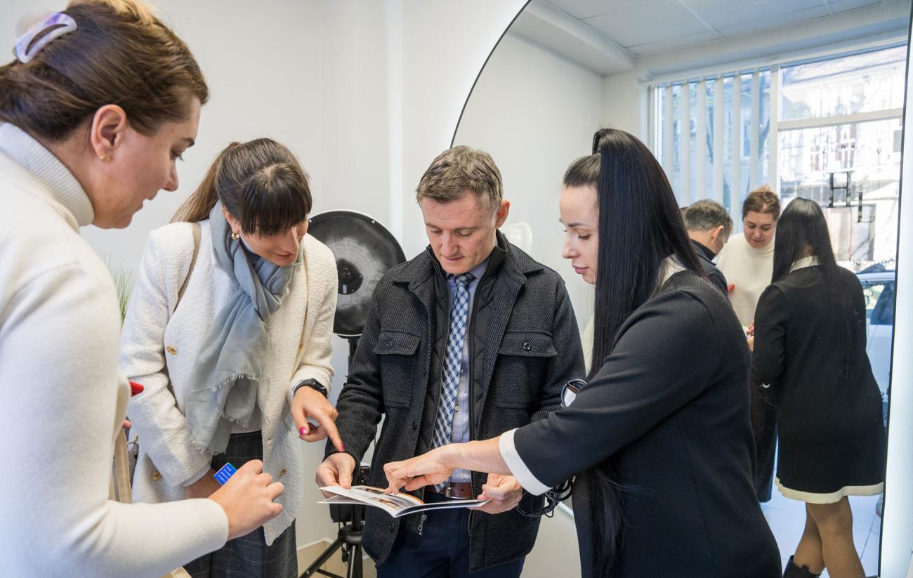 A group of people are reading a pamphlet in a beauty salon.