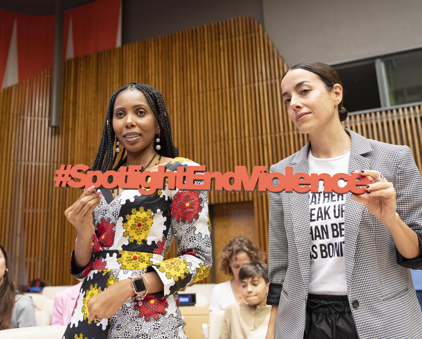 Participants at the EU-UN event on Eliminating Violence against women and girls show a sign that reads #SpotlightEndViolence.