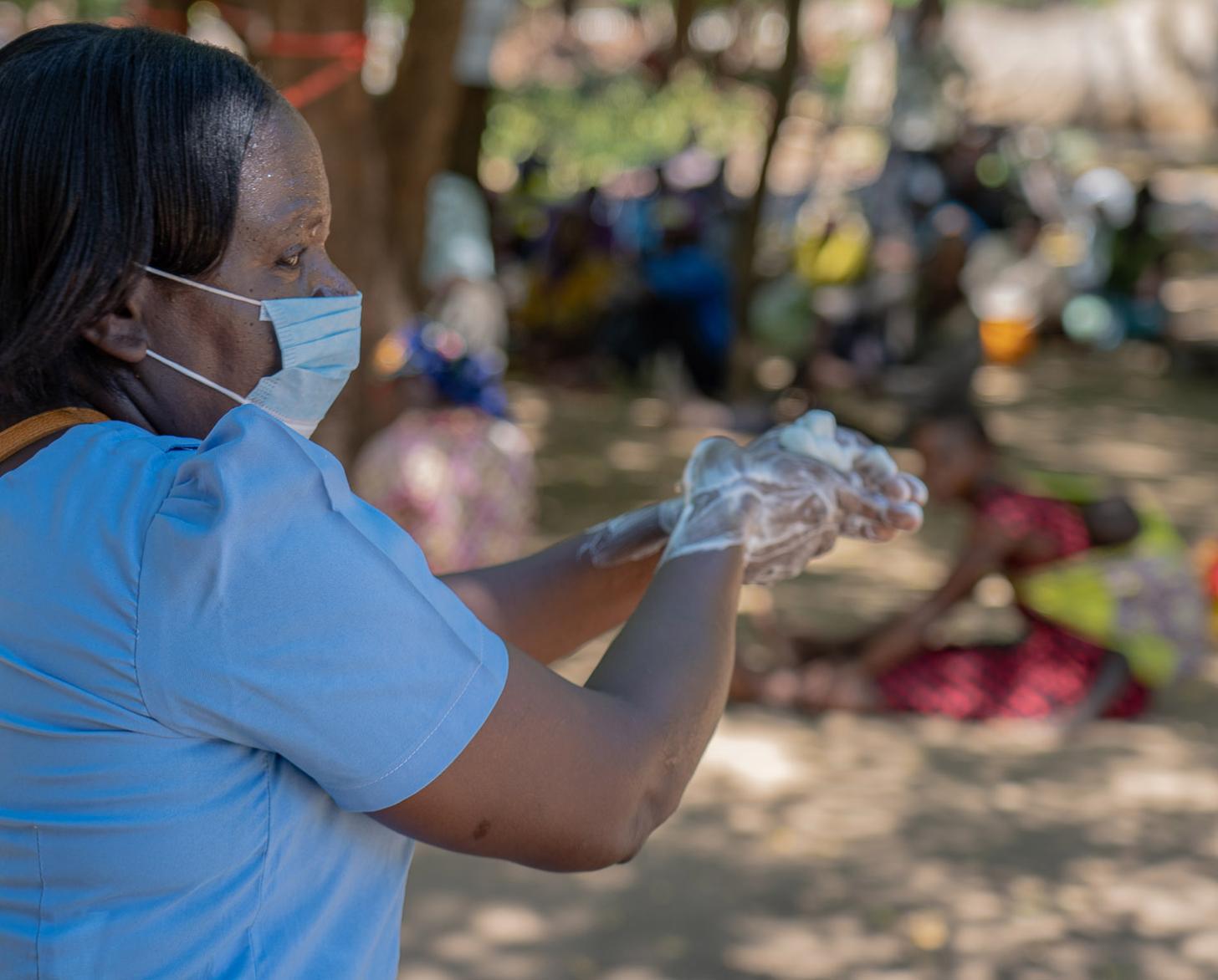 Caroline Allan, a district health officer, demonstrates proper hand-washing technique. 