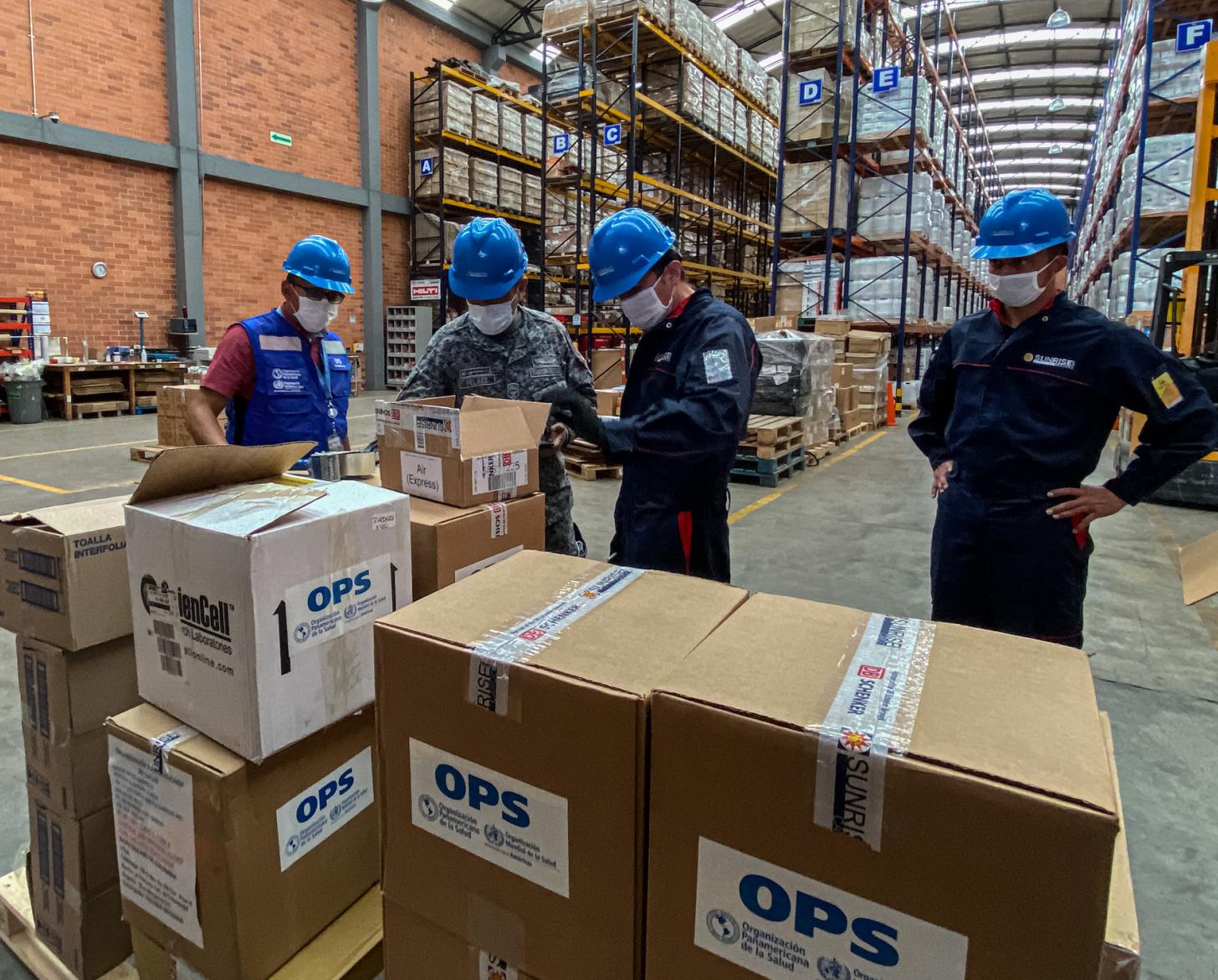 UN staffers at a warehouse stocked full of life-saving supplies.