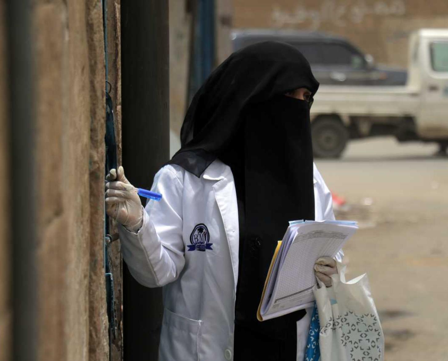 Healthcare workers are working in communities conducting surveys. 