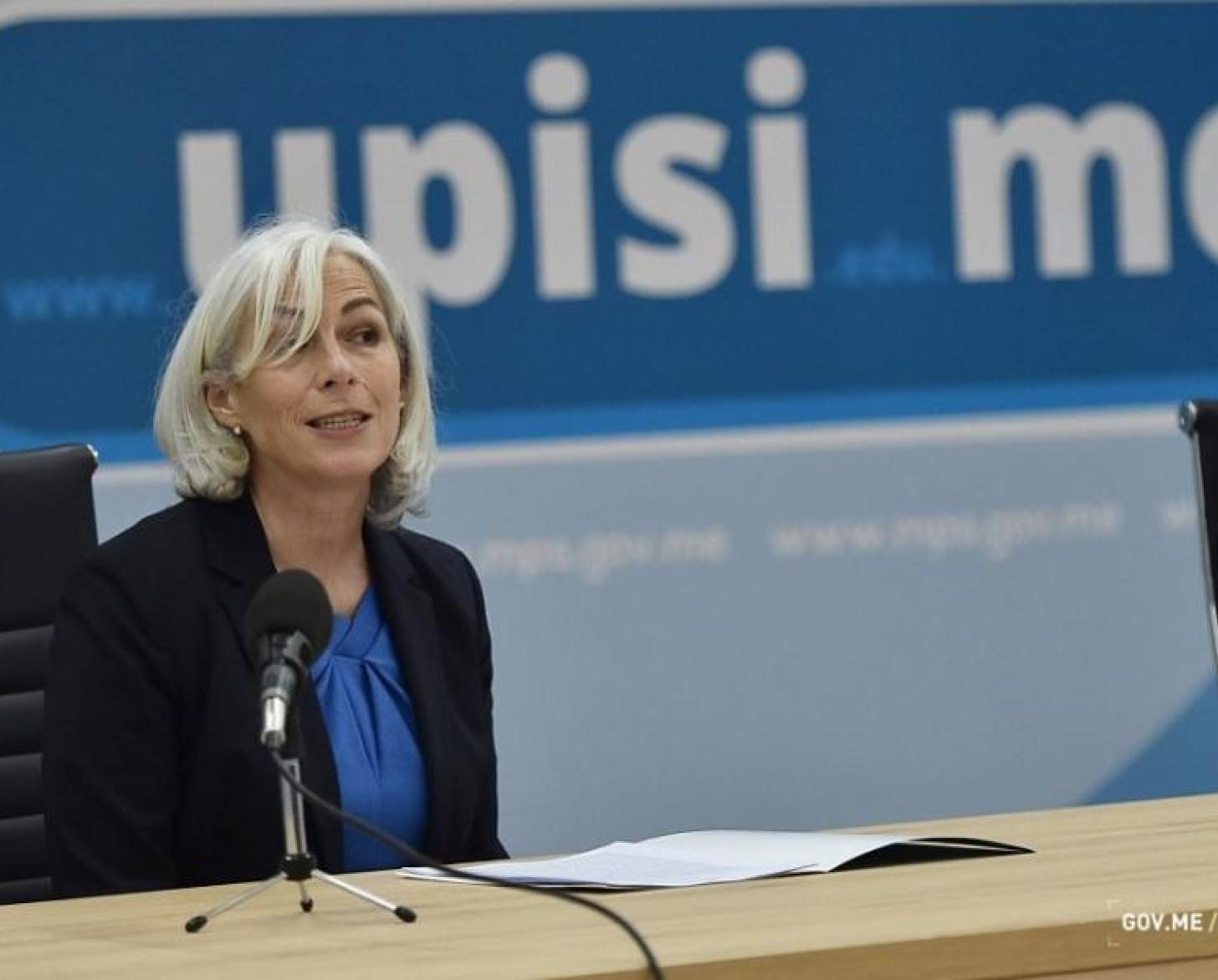 Fiona McCluney, Resident Coordinator of the UN System in Montenegro, is shown speaking into the microphone during a panel discussion.