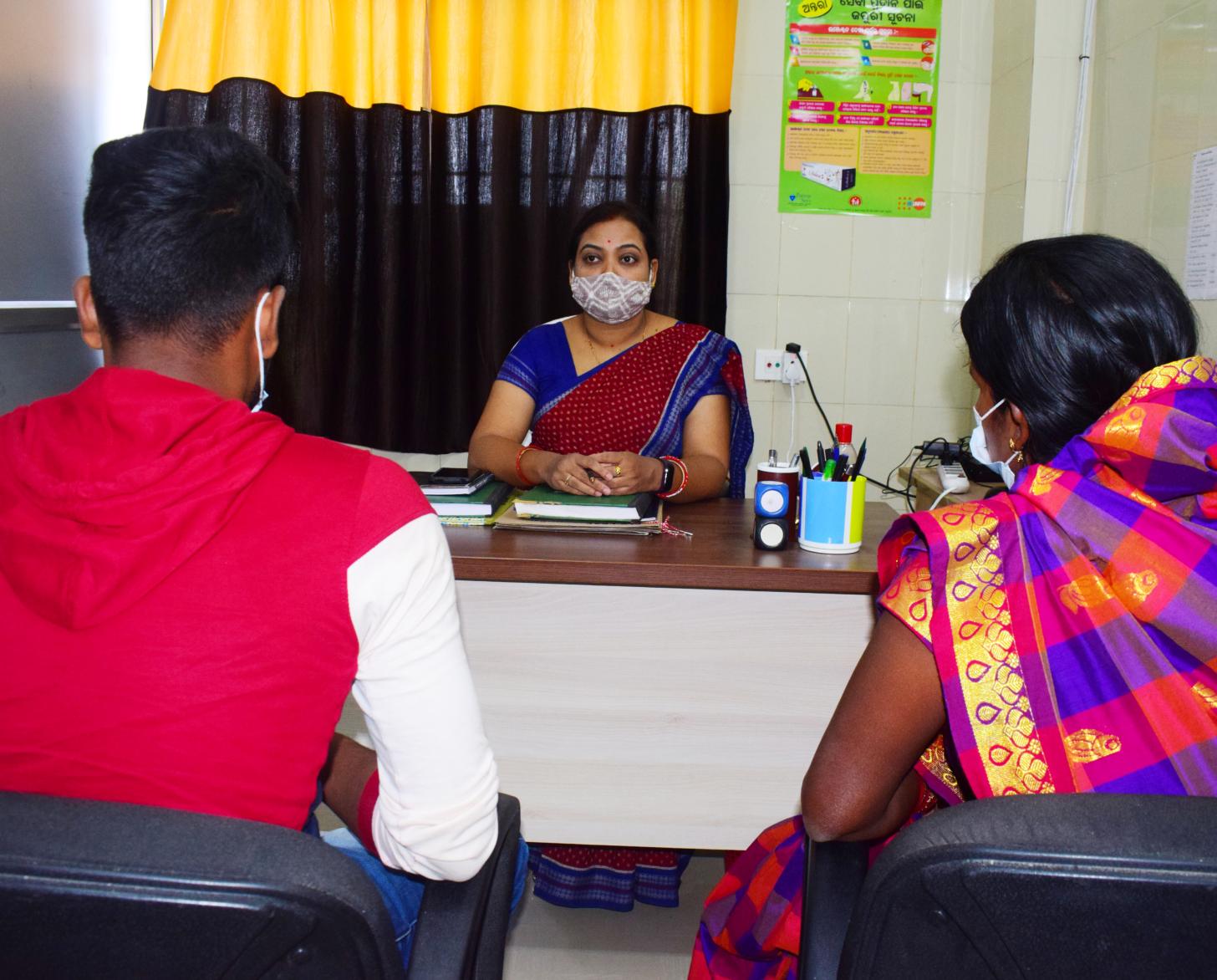One of the healthcare workers trained to counsel speaks with clients at their office.