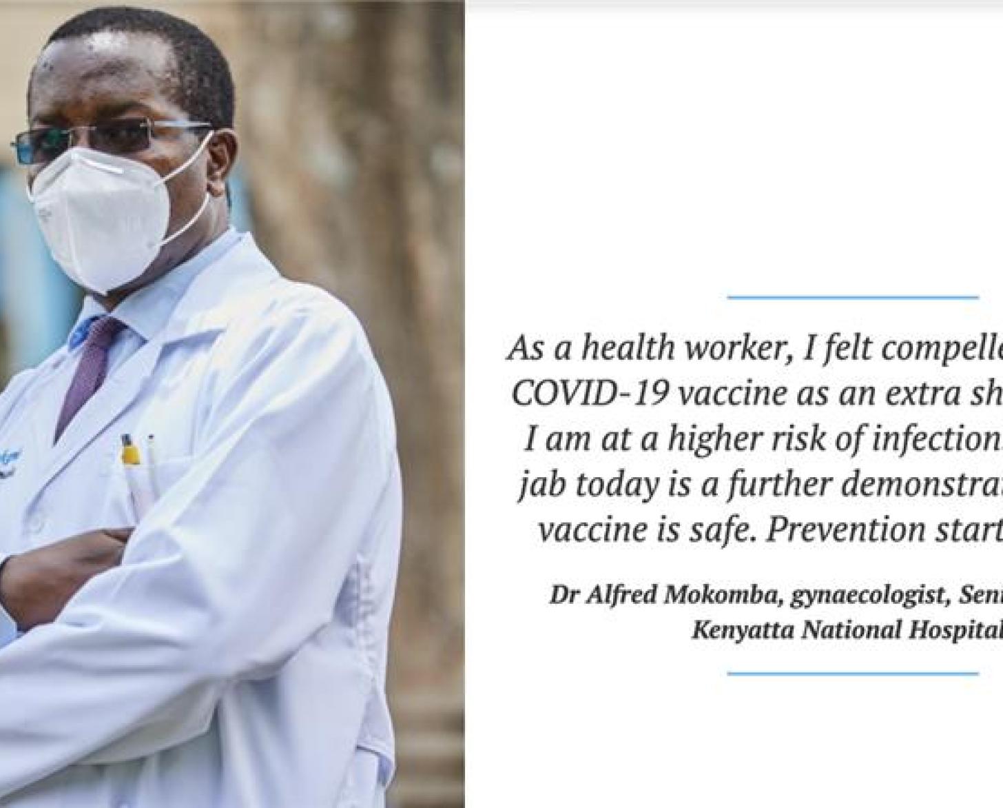 A man in a white lab coat and white surgical mask has his arms folded as he looks at the camera.