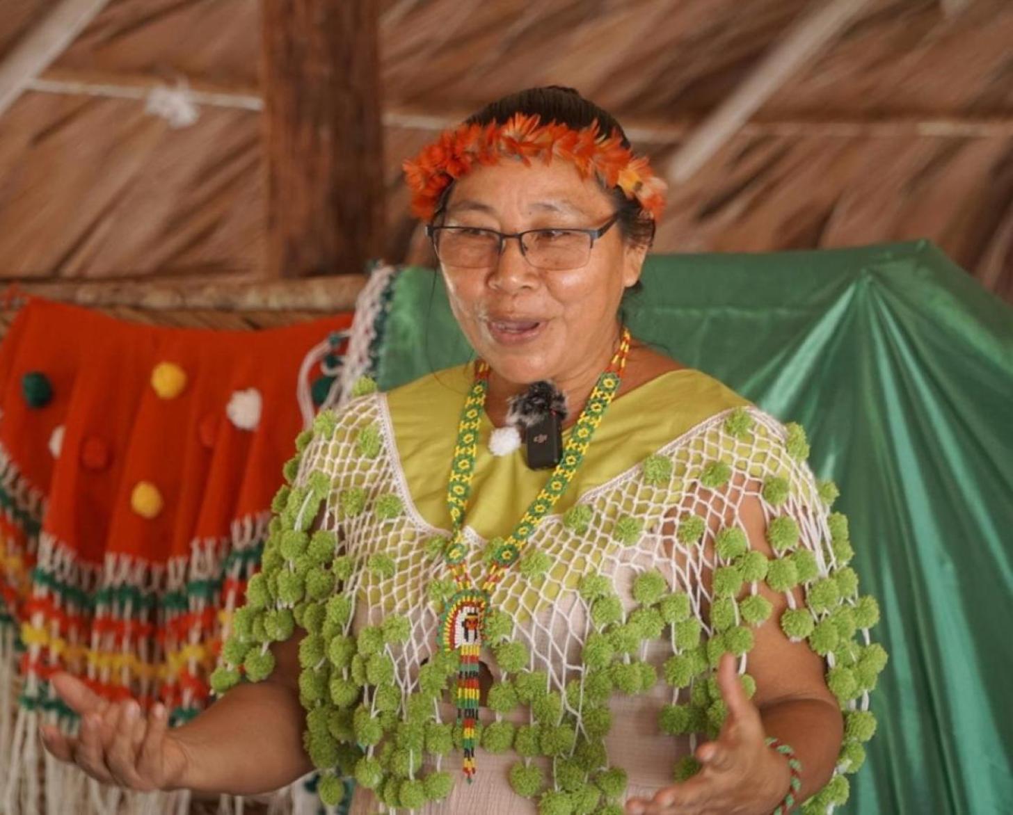 A woman is standing with a microphone